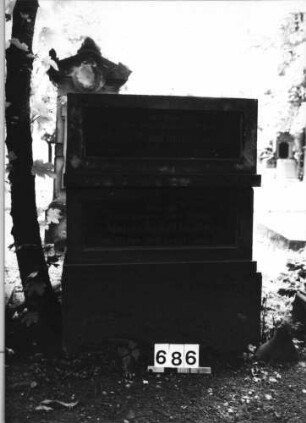 Grabstein 686 (Index: 99630188) Material: Sandstein m. 2 geschliffenen Granitplatte Zustand: leicht verwittert Maße HxBxT: 107x80x56 cm Beschreibung: drei Sockel übereinander, d. 2oberen m. breitrechteck. Schriftplatten Steinmetz: Kromer Besonderheit: Sockel gehören zu GrabNr. 685+686: Grabstein 686
