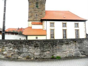 Evangelische Pfarrkirche - Ansicht von Norden mit Kirche (Kirchturm gotisch-Langhaus 18 Jhd neu erbaut) über Kirchhofmauer (Wehrgang mit Brüstung und Schießscharten abgetragen)