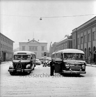 Markt: parkende Busse im Winter: im Hintergund rechts das Stadthaus, mittig das Rathaus, links die Kreissparkasse