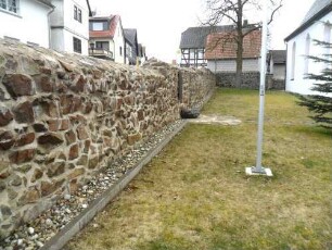 Krofdorf-Evangelische Kirche - Kirchhof im Norden mit Kirchhofmauer (Wehrgang mit Steinbrüstung und Schießscharten abgetragen) im Verlauf nach Osten