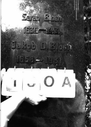 Grabstein 130 (Index: 100101671) Material: Granit, aufgesetzte Metallbuchstaben Zustand: gut Maße HxBxT: 156x48x19 cm Beschreibung: konische Stele, getreppter Sockel, rund eingezogener giebelartiger Abschluß Symbolik: Davidstern, Blütenbordüre Besonderheit: Doppelgrab: Grabstein 130A