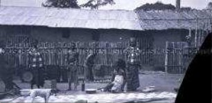 Afrikanische Frauen und ein Junge, vermutlich Bedienstete der Station Molundu, beim Verrichten von Arbeiten