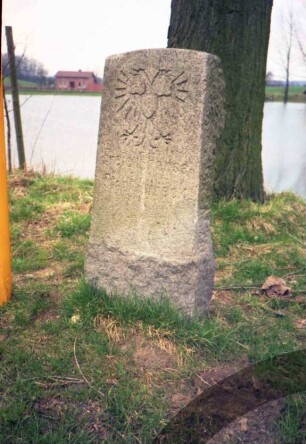 Kreis Herzogtum Lauenburg: Grenzstein mit Lübecker Doppeladler: dahinter Baum, Teich