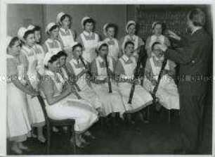 Krankenschwestern singen im Chor und spielen Blasinstrumente