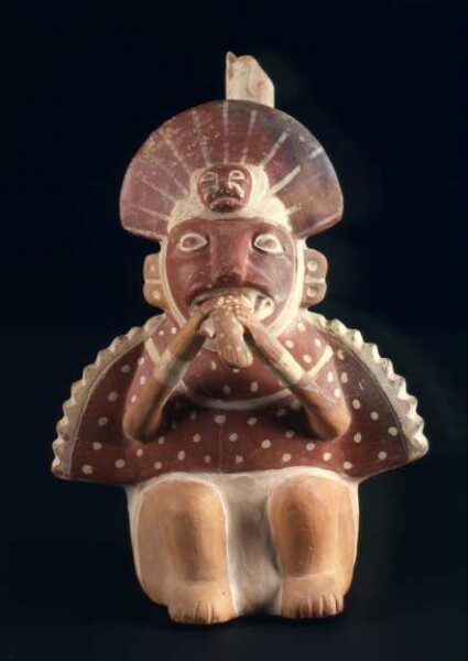 Seated anthropo-zoomorphic figure eating a fish