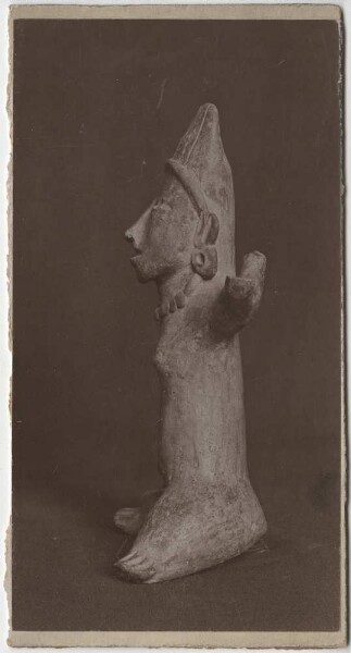 Clay figure of a seated woman (side view)