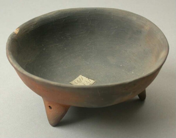 Three-footed clay bowl