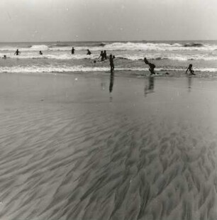 Golf von Guinea, Ghana. Strand mit Ebbegangeln und Badetreiben bei Accra
