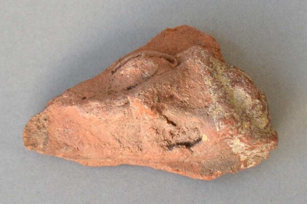 Clay face (fragment)