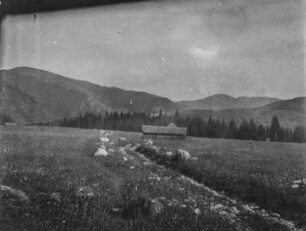 Amerikanische Landschaft : Landschaft mit Hügeln, im Vordergrund zwei Hütten