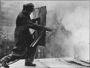 Hamburg 1940 - Luftschutz-Vorführung : Mit der zunehmenden Bombardierung deutscher Städte wird 1940 der Luftschutz und die damit verbundenen Aufgaben immer wichtiger. Hier wird der Bevölkerung Hamburgs im Rahmen einer Luftschutzübung vorgeführt, wie ein durch Brandbomben ausgebrochener Dachstuhlbrand mit Wasser bekämpft werden kann.