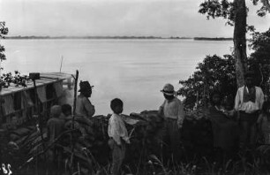 Indigene Bevölkerung : Indigene, neben einem Tourismusdampfer, am Ufer des Rio Paraná.