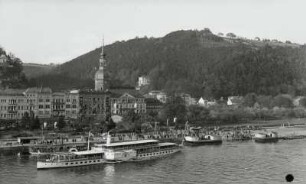 Personen-Seitenraddampfer "Leipzig" (1929; Werft Dresden-Laubegast) in Fahrt stromab unmittelbar nach dem Ablegen von der Landungsbrücke : Bad Schandau. Personen-Seitenraddampfer "Leipzig" (1929; Werft Dresden-Laubegast) in Fahrt stromab unmittelbar nach dem Ablegen von der Landungsbrücke. Blick vom linken Uferhang über die Elbe auf Hotelbauten und Stadtkirche
