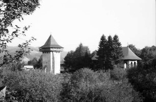 Humor: Kloster, Außenansicht mit Turm, von der Wiese