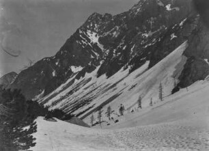 Berglandschaft : Blick über das verschneite Stallental. Vereinzelt stehen Tannen, die Berge sind teilweise mit Schnee bedeckt.
