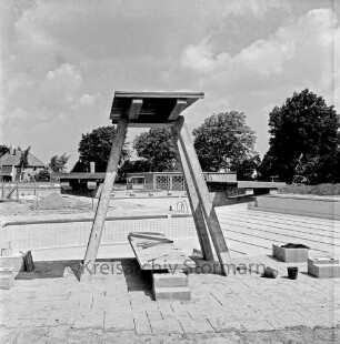 Freibad: Reeshoop: Schwimmbecken mit Fliesen vor Fertigstellung: Sprungturm in Bau: im Hintergrund Filterhaus