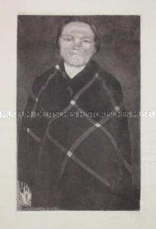 Schwangere Frau mit kariertem Umhang