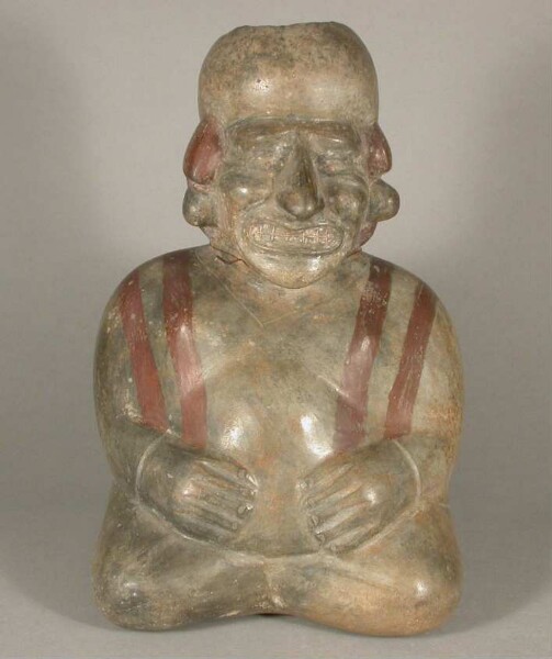 Seated anthropomorphic figure with facial mutilation