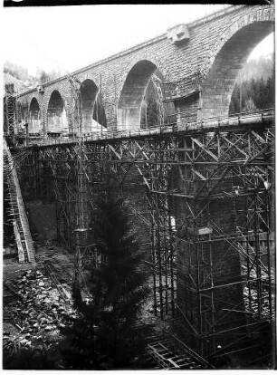Fertig gestellter Viadukt mit Brückengeländer und Fahrgerüst