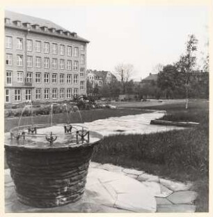 Grünflächen am Verwaltungsgebäude der Böhme Fettchemie, Chemnitz: Gebäude mit Trinkbrunnen und Plattenverlegung