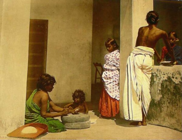 South of India. Women grinding and children