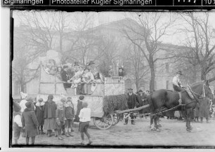 Fasnacht Sigmaringen; Umzugswagen des Gesangsvereins Frohsinn auf dem Leopoldsplatz vor der Landesbank
