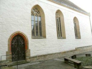 Stadtkirche-Langhaus (Gotischer Neubau auf Romanischem Vorgänger) über Traufseite Nord mit Maßwerkfenstern sowie spitzbogig gewändeter Tür