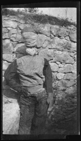 Chauvoncourt (Dep. Meuse, Frankreich): an einer Steinmauer lehnende lebensgroße Strohpuppe ("(...) vom Unternehmen am 24.8.1916")