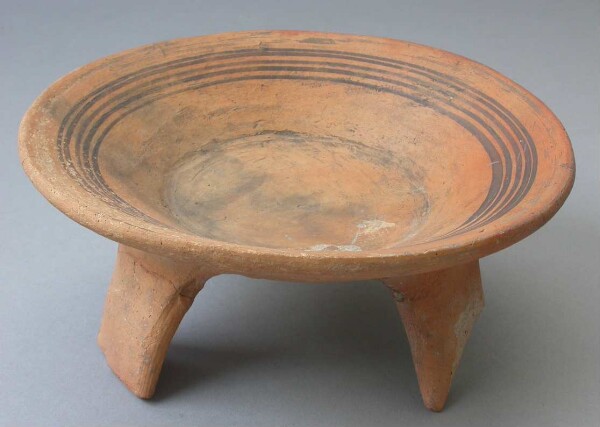 Three-footed clay bowl