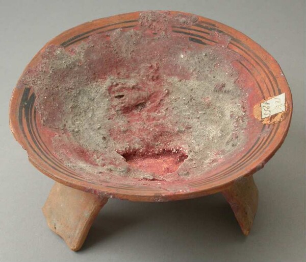 Three-footed clay bowl