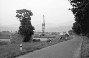 Heitersheim: Bohrturm und Baum im Vordergrund; bei Heitersheim