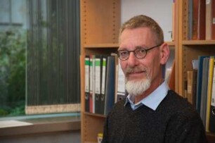 Porträt Perk Loesch, Fachreferent der SLUB : Porträt des Kunstwissenschaftlers Perk Loesch, Fachreferent und von 1996 bis 2019 Leiter der Handschriftenabteilung an der Sächsischen Landesbibliothek – Staats- und Universitätsbibliothek Dresden (SLUB). Aufnahme an seinem Schreibtisch