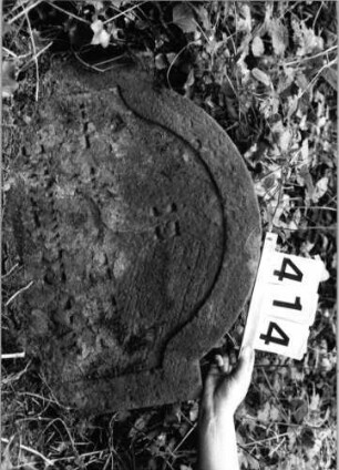 Grabstein 414 (Index: 99803669) Material: Sandstein Zustand: z. T. völl. verwitt/Textverl/eingesunk. Maße HxBxT: 47x60x8 cm Beschreibung: Stele mit eingezogenem Rundbogen und profiliertem Rand: Grabstein 414