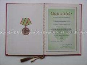Urkunde zur Verdienstmedaille der Organe des MdI in Bronze (in Mappe)