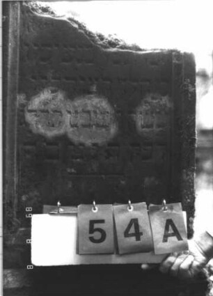 Grabstein 54 (Index: 99799410) Material: Sandstein Zustand: verwittert, oberer Teil abgebrochen Maße HxBxT: 107x54x16 cm Beschreibung: Stele, Oberteil abgebrochen, Schriftfeld eingetieft, Sockel: Grabstein 54A