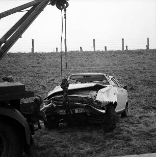 A 1: bei Stapelfeld: Verkehrsunfall: Pkw rammt Pkw und prallt gegen Brückenpfeiler: neben Fahrbahn Unfall-Pkw an Haken von Abschleppwagen: hinten Böschung, obenauf Zäune