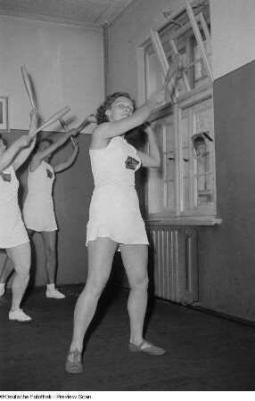 Sportlerinnen während einer Gymnastikübung mit Keulen