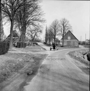 Dorfstraße: hinten Mitte Wirtschaftsweg nach Altenweide: davor Frau mit Kinderwagen und Kind: links Baumreihe: im Hintergrund Bauernhäuser