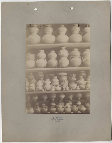 Shelf wall full of clay vessels, occasional figurative ceramics. L. Adam Collection