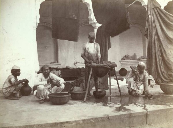 Street scene, men washing clothes