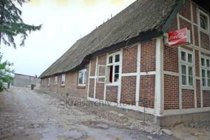 Papierholz 1: Fachwerkhaus mit Reetdach: Gasthaus Zur Hahnheide: südliche Traufseite: rechts Giebelfront mit Reklameschild