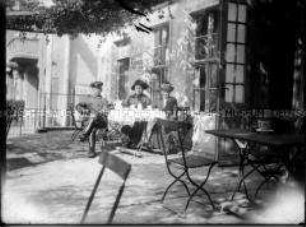 Soldat mit zwei Frauen vor einem Café sitzend, 1. Weltkrieg