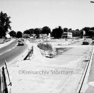 Möllner Landstraße mit Pkws: Ausbau um neues Ortszentrum: hinten neue Abzweigung der Bahnhofstraße Richtung Reinbek: vorn rechts neue Straße: hinten rechts Rathaus und Bürgerhaus Glinde [später Marcellin-Verbe-Haus] und Geschäftshäuser
