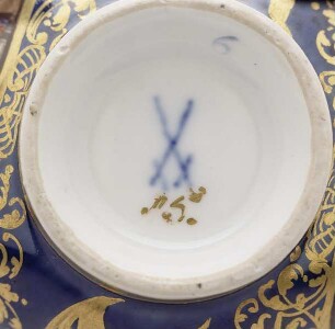 Henkeltasse und Unterschale mit königsblauem Fond, Blumendekor und Hafenszenen — Porzellanmarke
