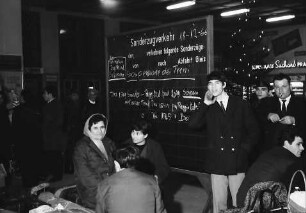 Freiburg: Hauptbahnhof. Italienische "Gastarbeiter" fahren zu Weihnachten nach Hause, vor Zugankündigungstafel