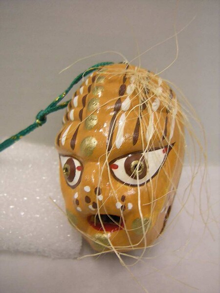 Bell in the shape of a miniature mask