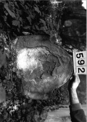 Grabstein 592 (Index: 99802849) Material: Sandstein Zustand: abgeblätt/völl. Textverlust Maße HxBxT: 52x52x10 cm Beschreibung: Stele mit Karniesbogen: Grabstein 592