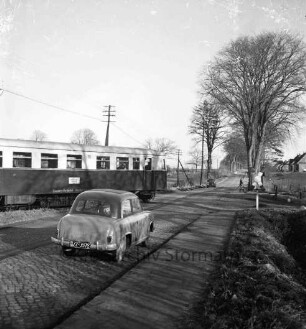 Bundesstraße B 75: Bahnübergang: ein Triebwagen der Elmshorn-Barmstedt-Oldesloer Eisenbahn