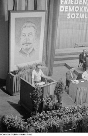 Blick auf das Rednerpult mit einem Porträt von Josef Stalin im Hintergrund
