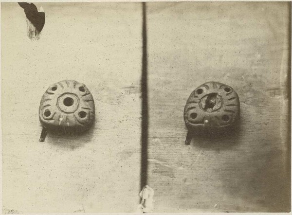 Two perforated stone objects (stone beads?)